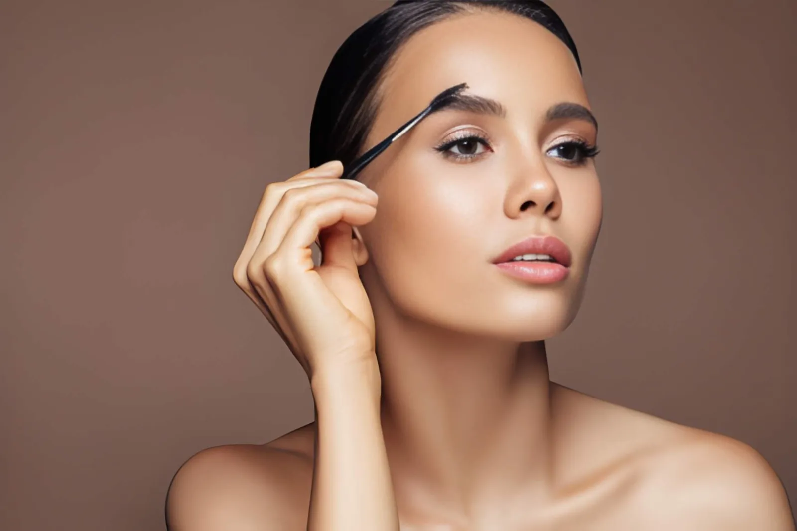 Woman brushing tinted eyebrows