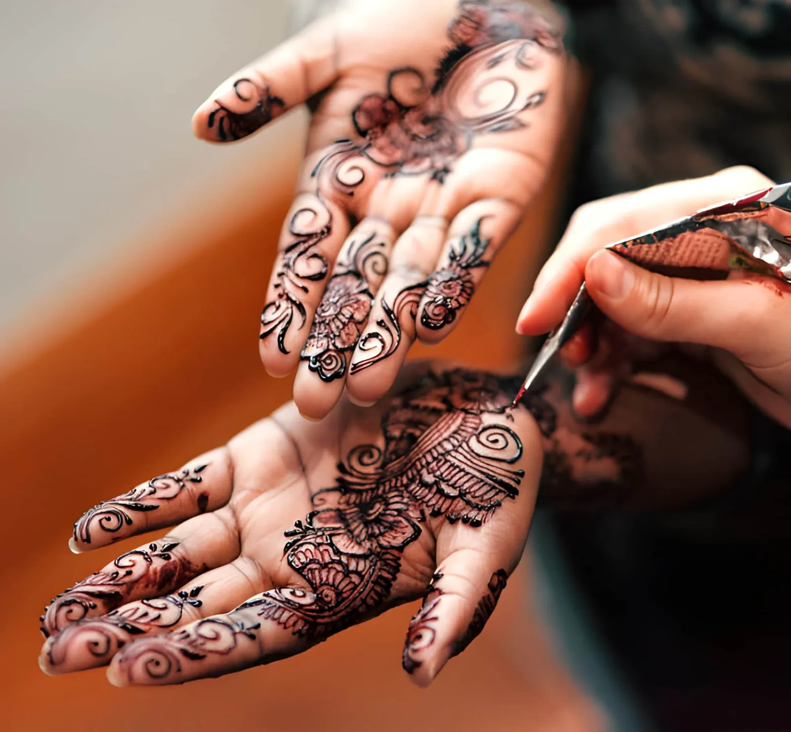 Bridal mehndi being applied to hands