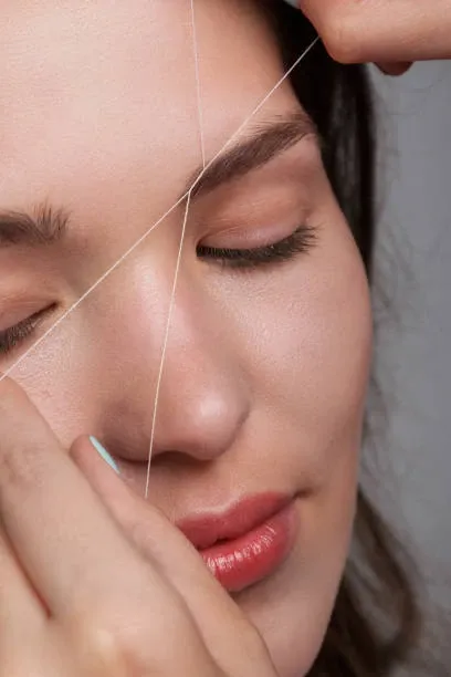 Eyebrow threading with cotton thread